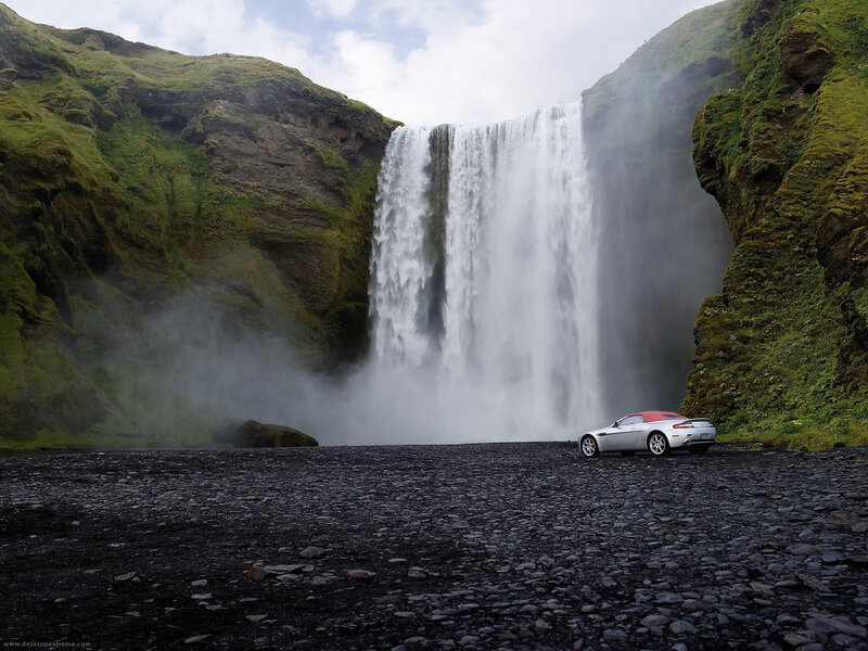 Car at waterfall in Iceland