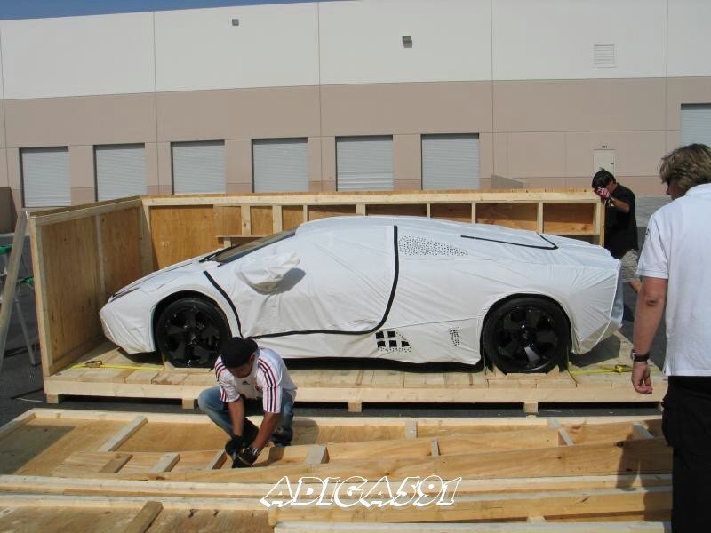 Car being loaded into crate