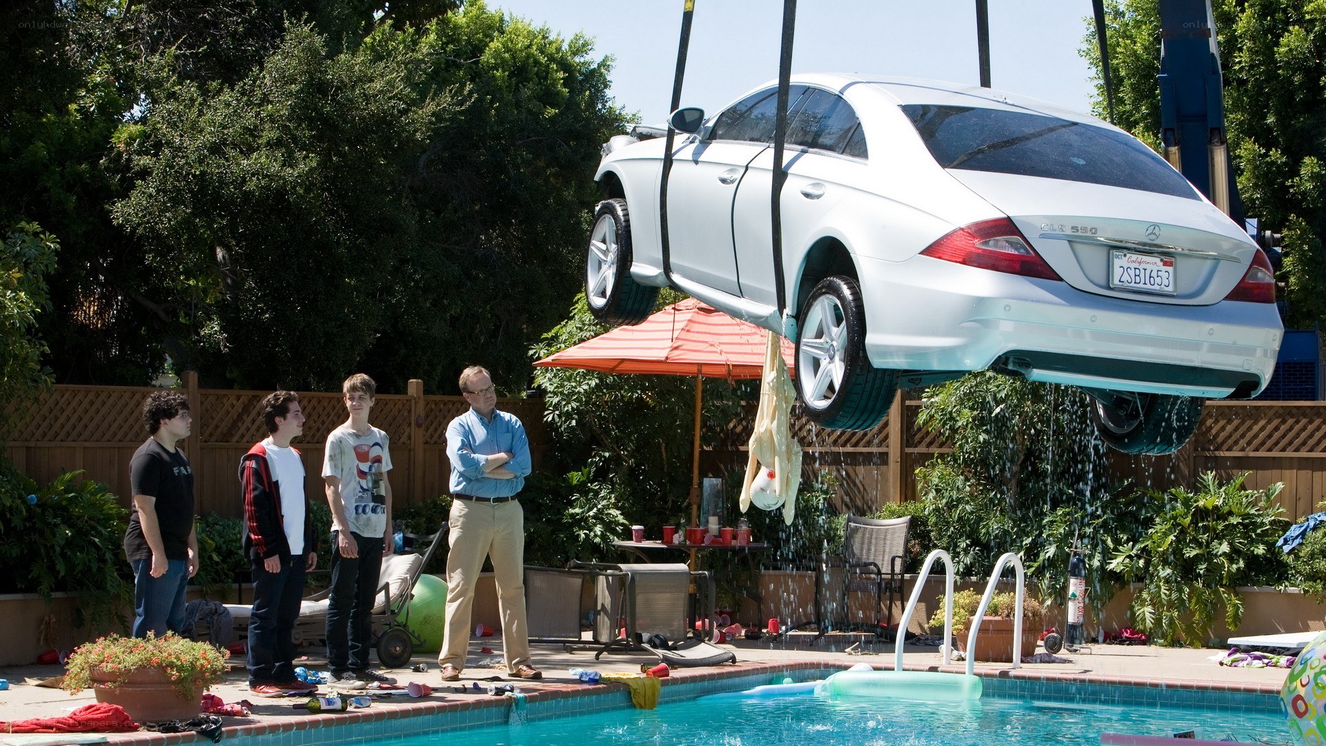 Car being lowered into pool