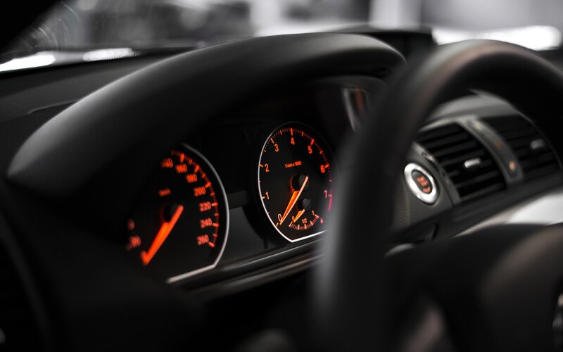 car dashboard with illuminated gauges