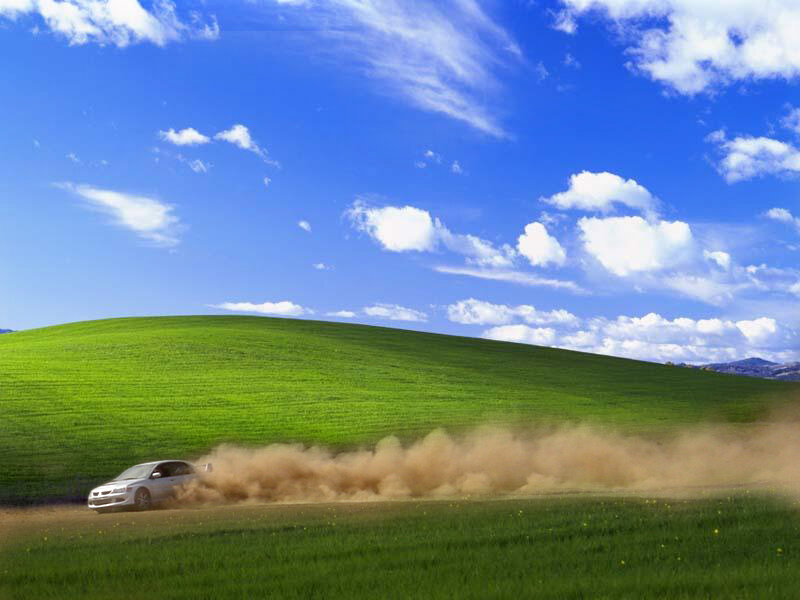 car drifting on a green hill