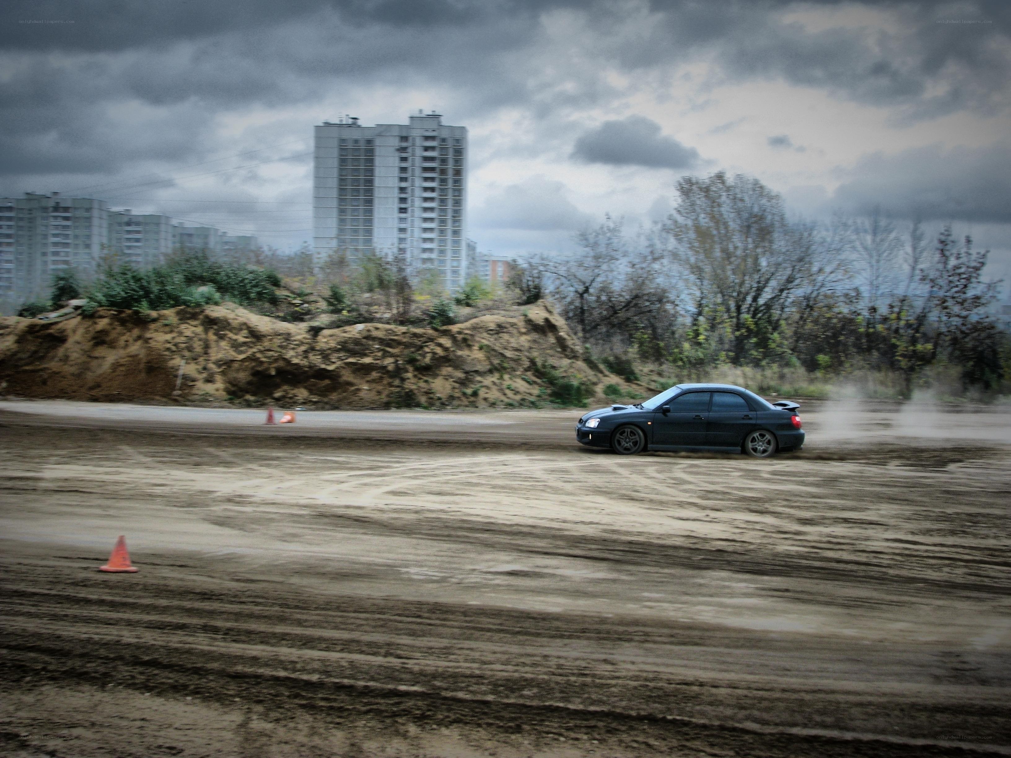 Car drifting on dirt track