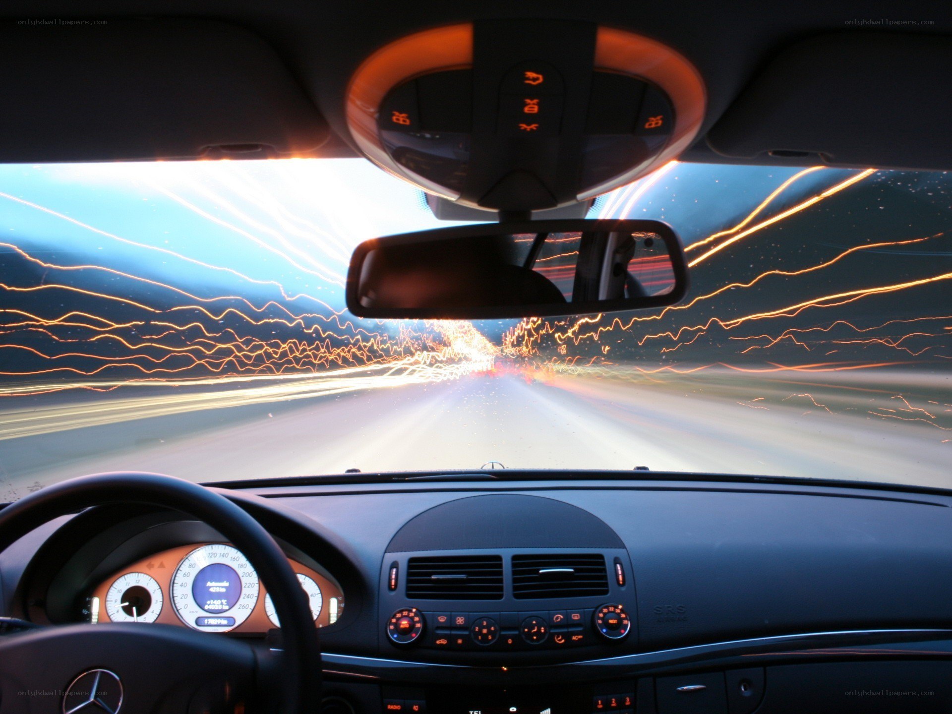 car driving at night with light trails