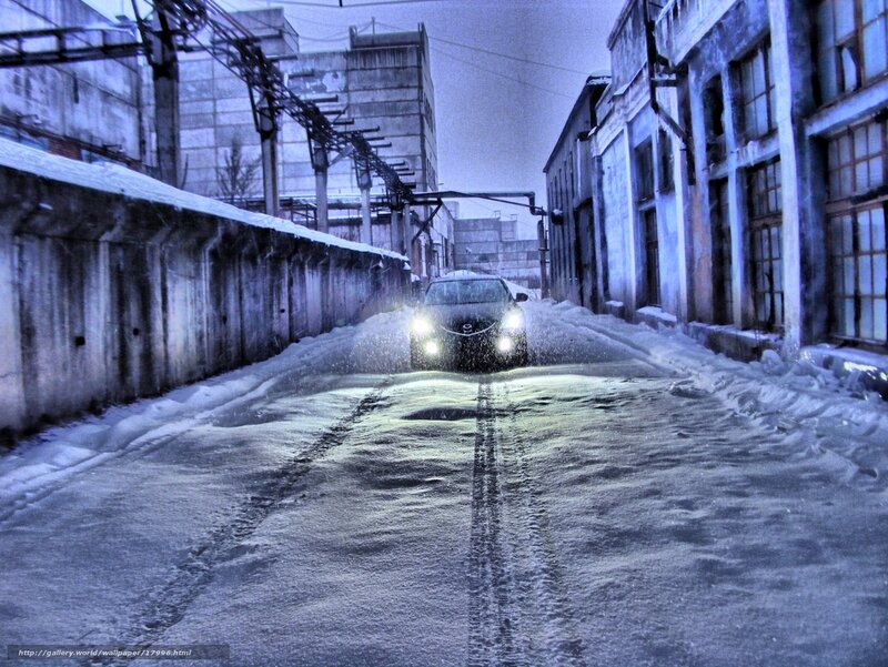 Car driving in snowy alley