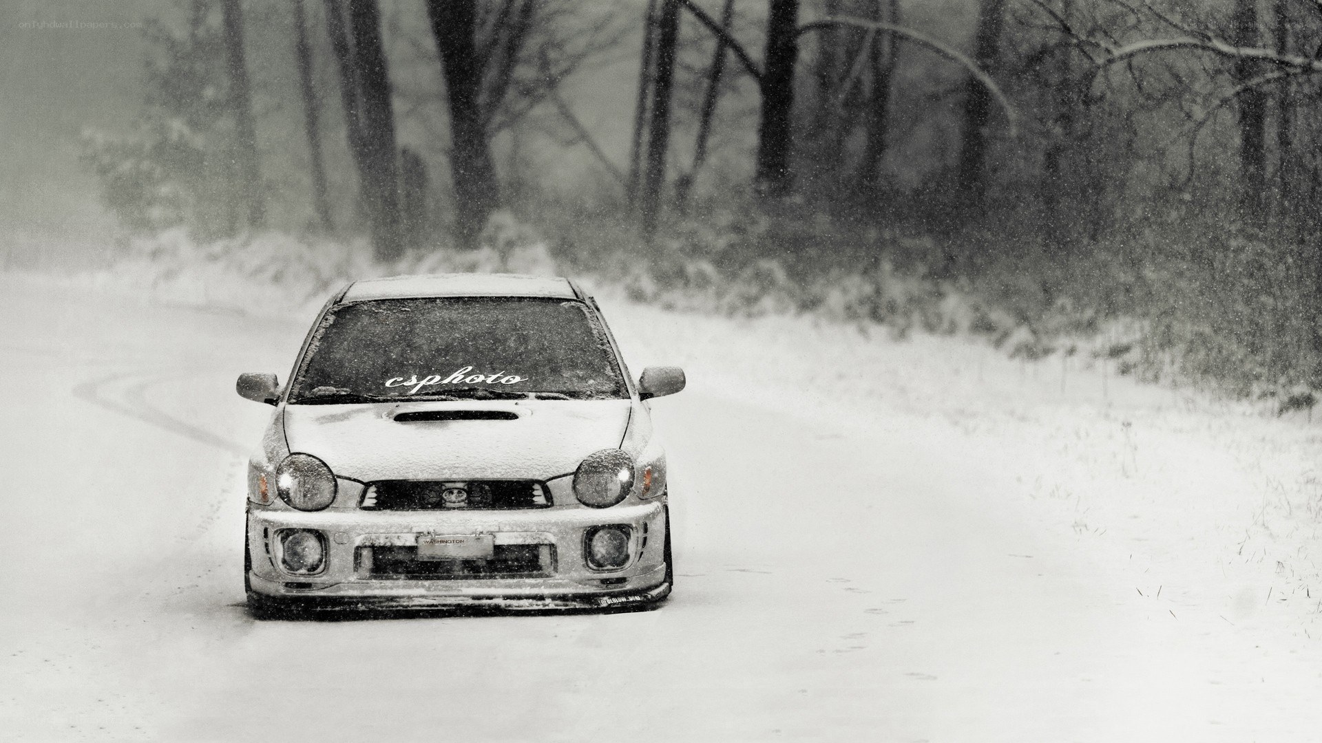 Car driving in snowy forest