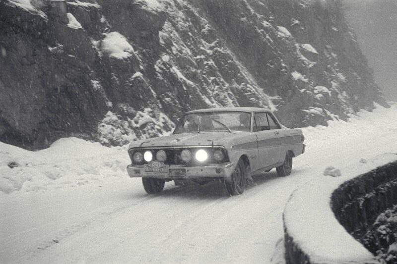 Car driving in snowy mountains