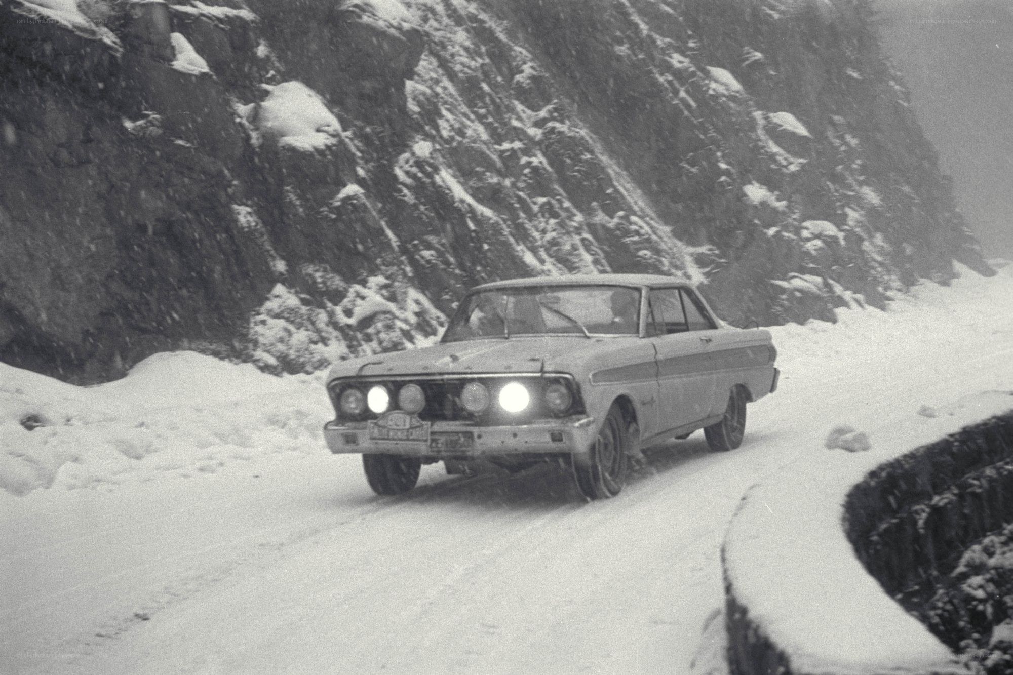 Car driving in snowy mountains
