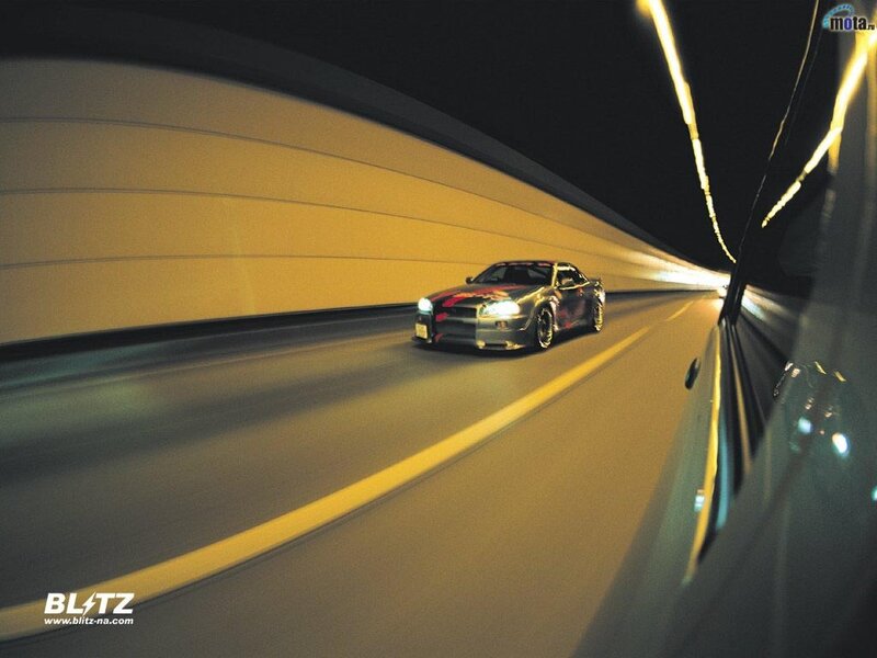 Car driving in tunnel at night