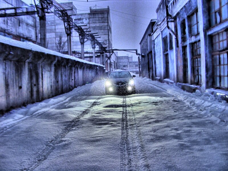 Car driving on snowy alley