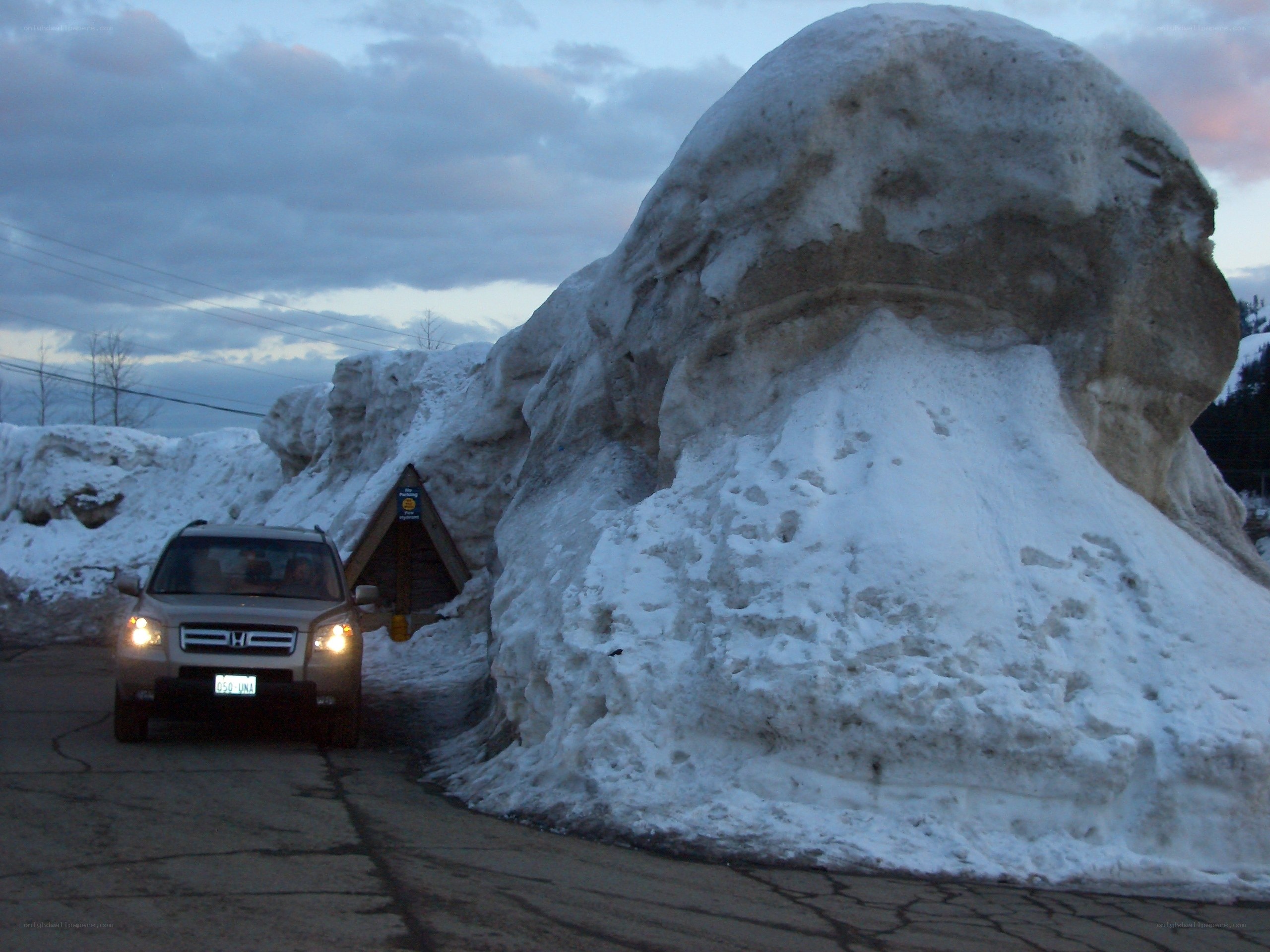 Car driving through snow tunnel