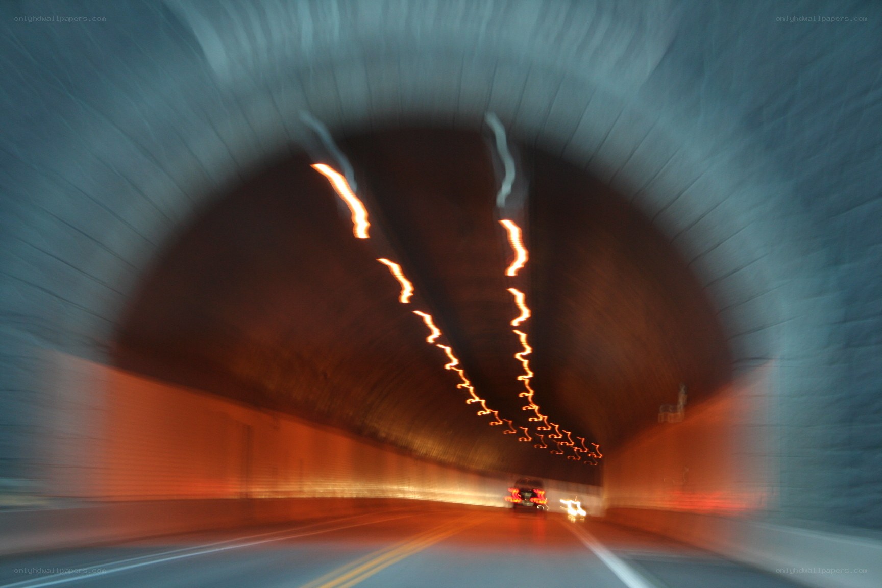 Car driving through tunnel