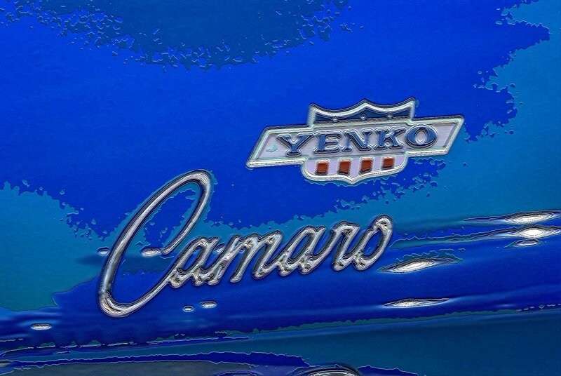 Car Emblem on Blue Surface — Dramatic