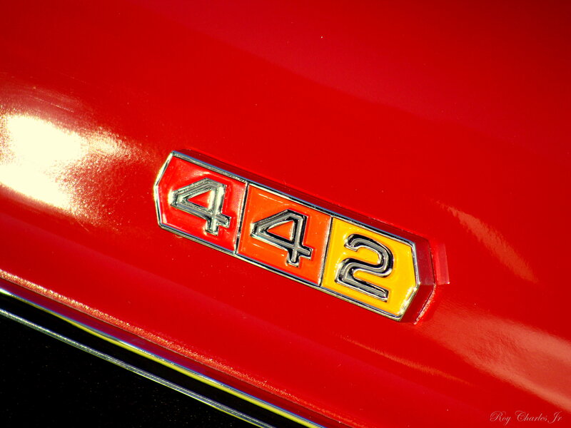 Car Emblem on Red Surface — Dramatic