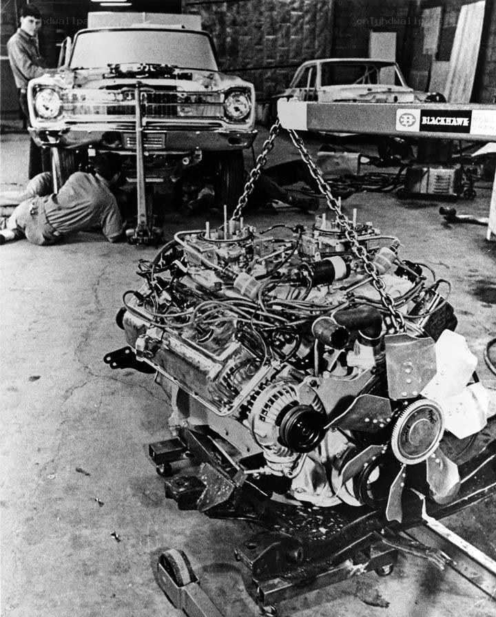 Car engine being removed in garage