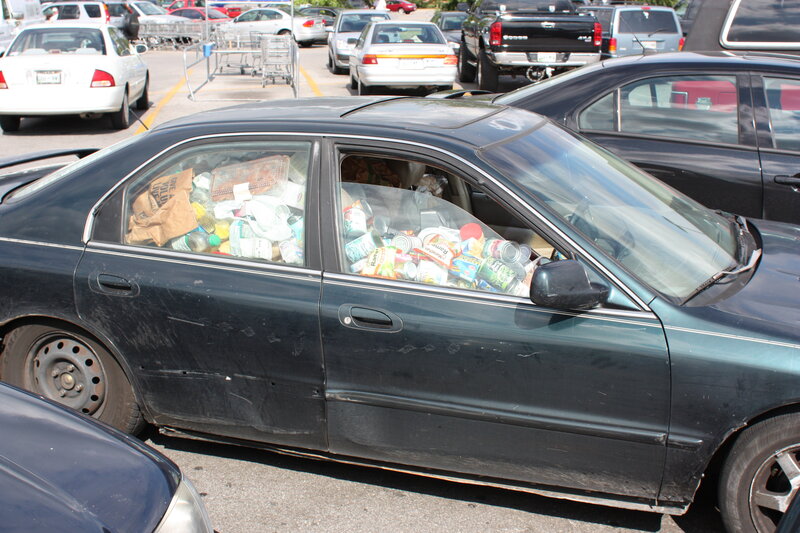 Car filled with trash in parking lot