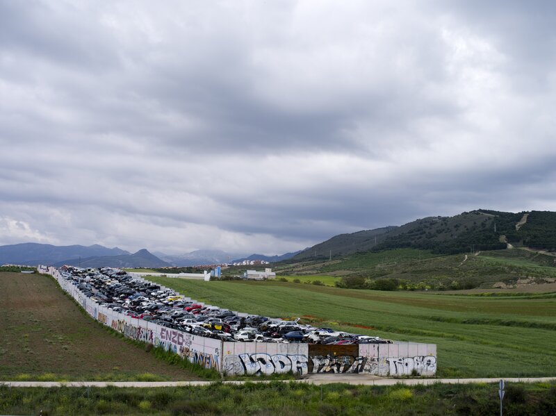 Car graveyard in rural landscape