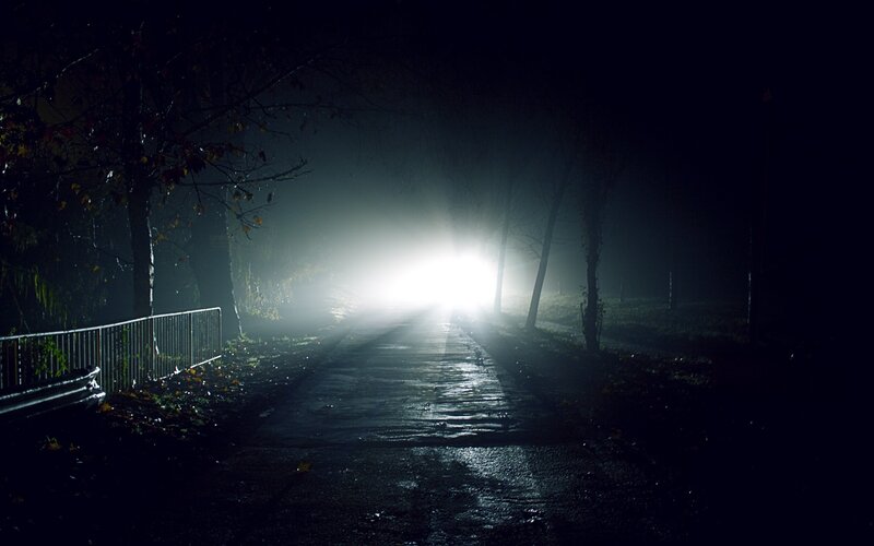 Car headlights in foggy night