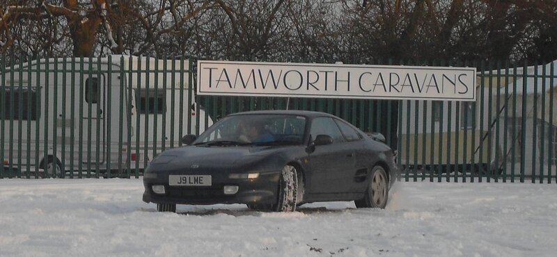 Car in snowy parking lot