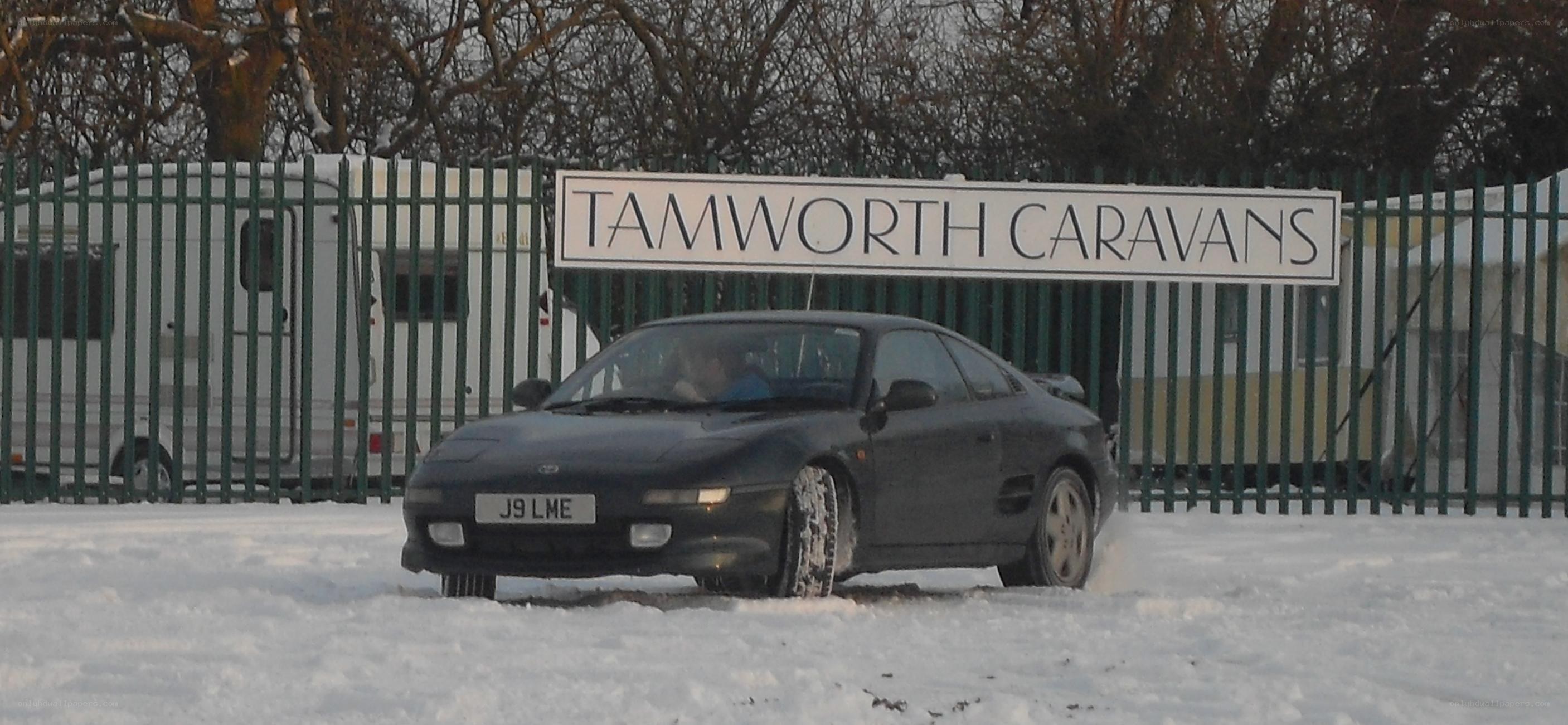 Car in snowy parking lot