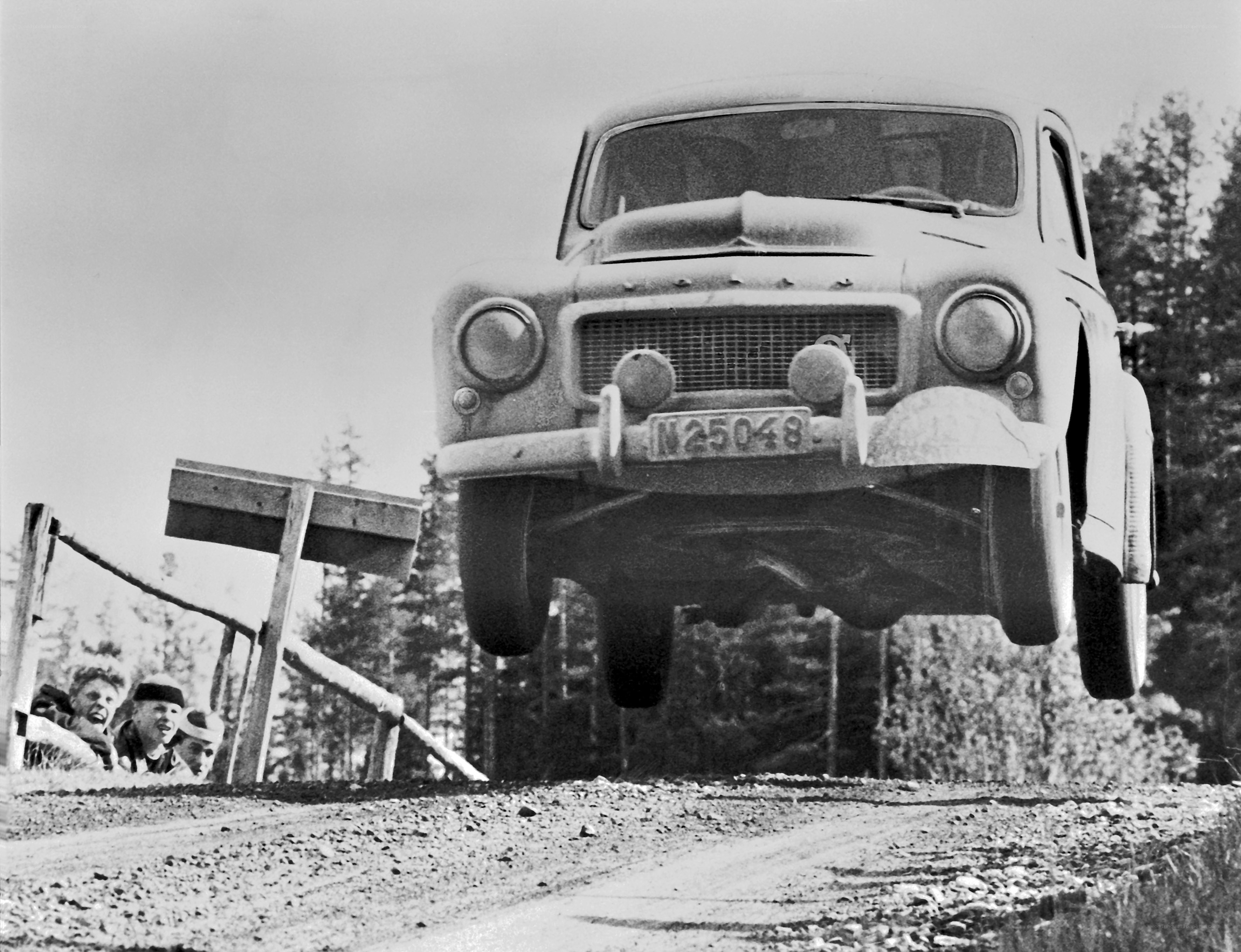 Car jumping over a dirt road