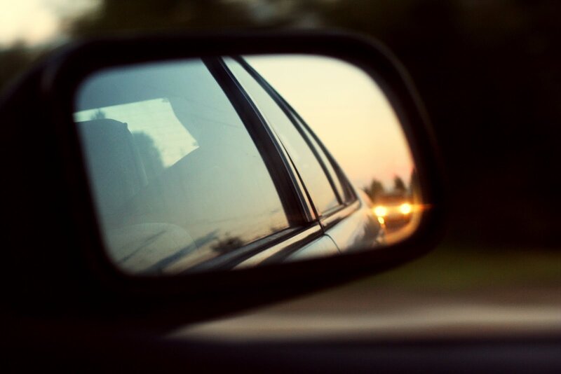 Car mirror reflecting sunset
