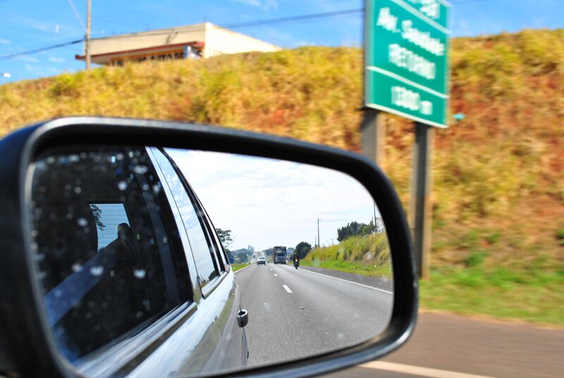 Car mirror view of highway