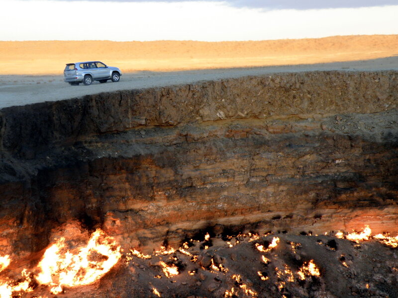 Car near burning gas crater