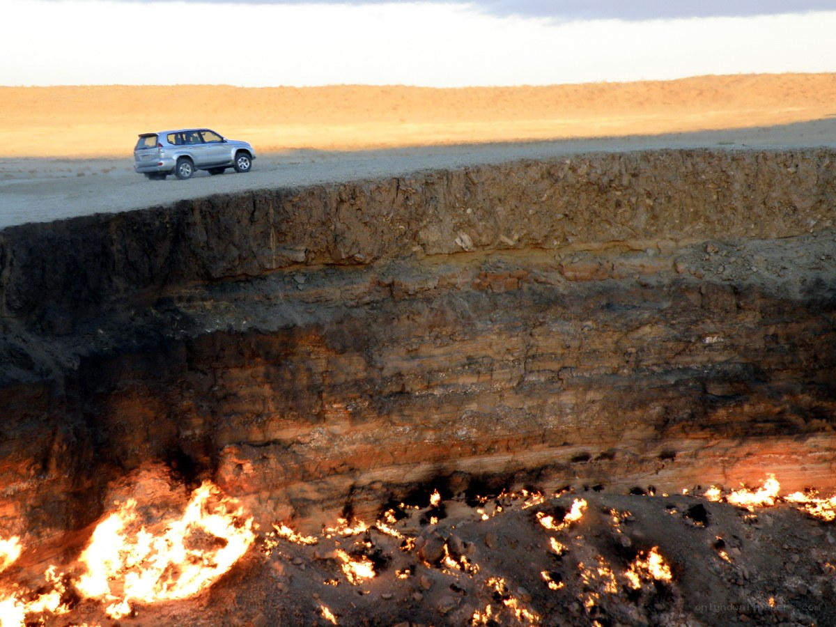 Car near burning gas crater