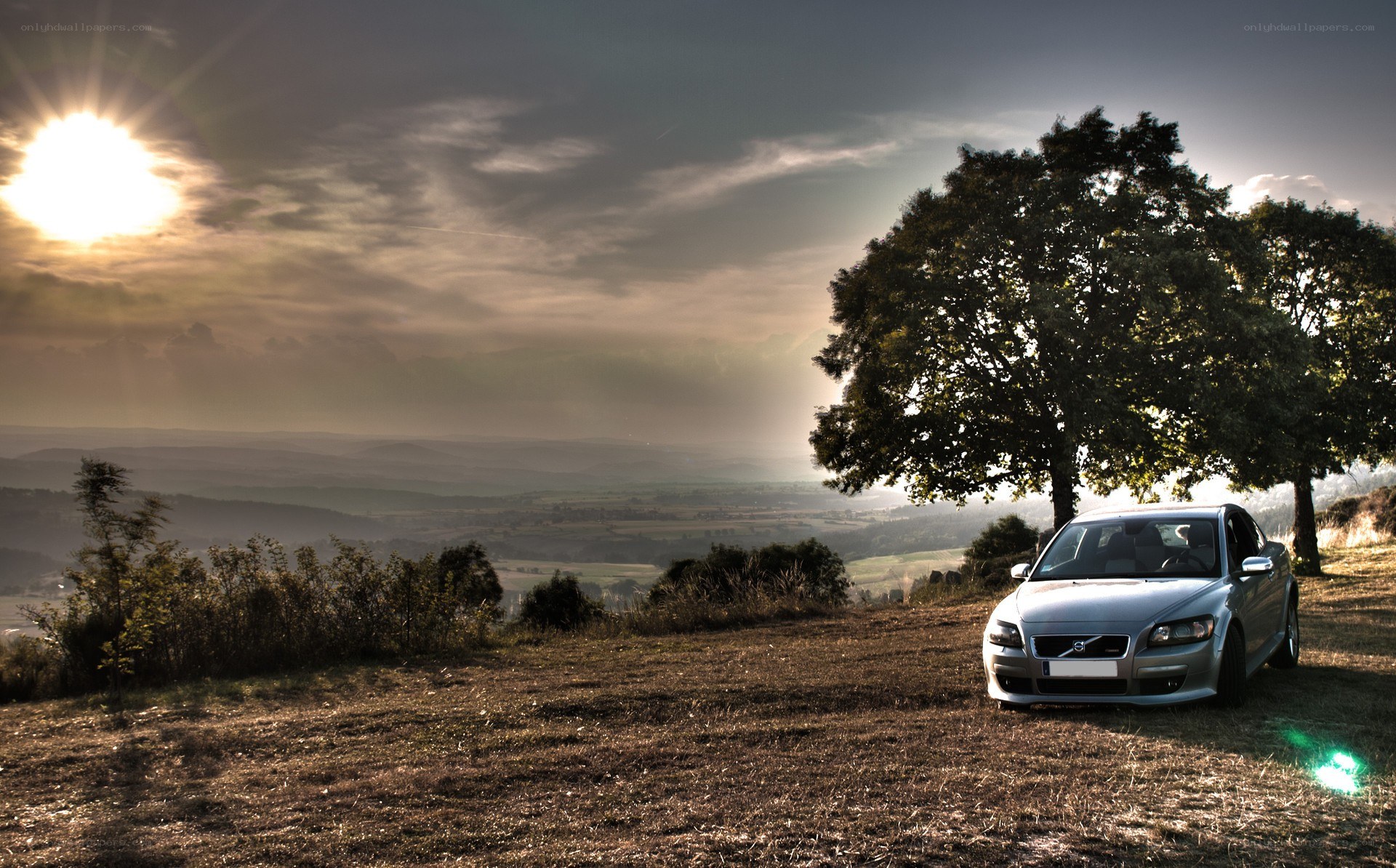 Car on a hill at sunset