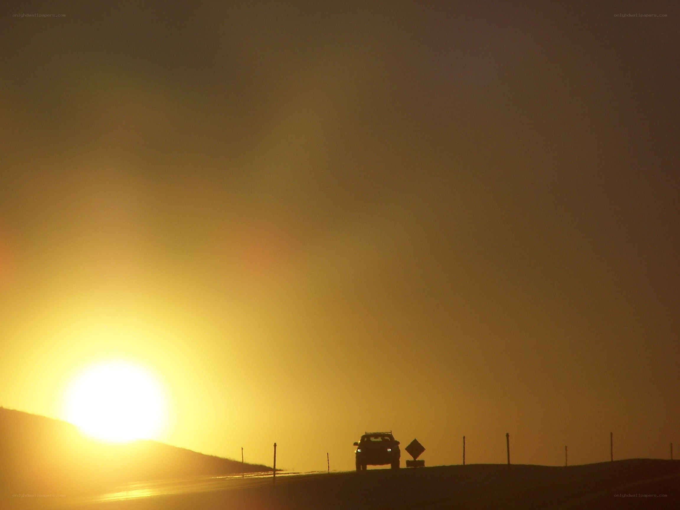 Car on a road at sunset