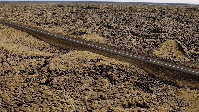 Car on a road in a barren landscape