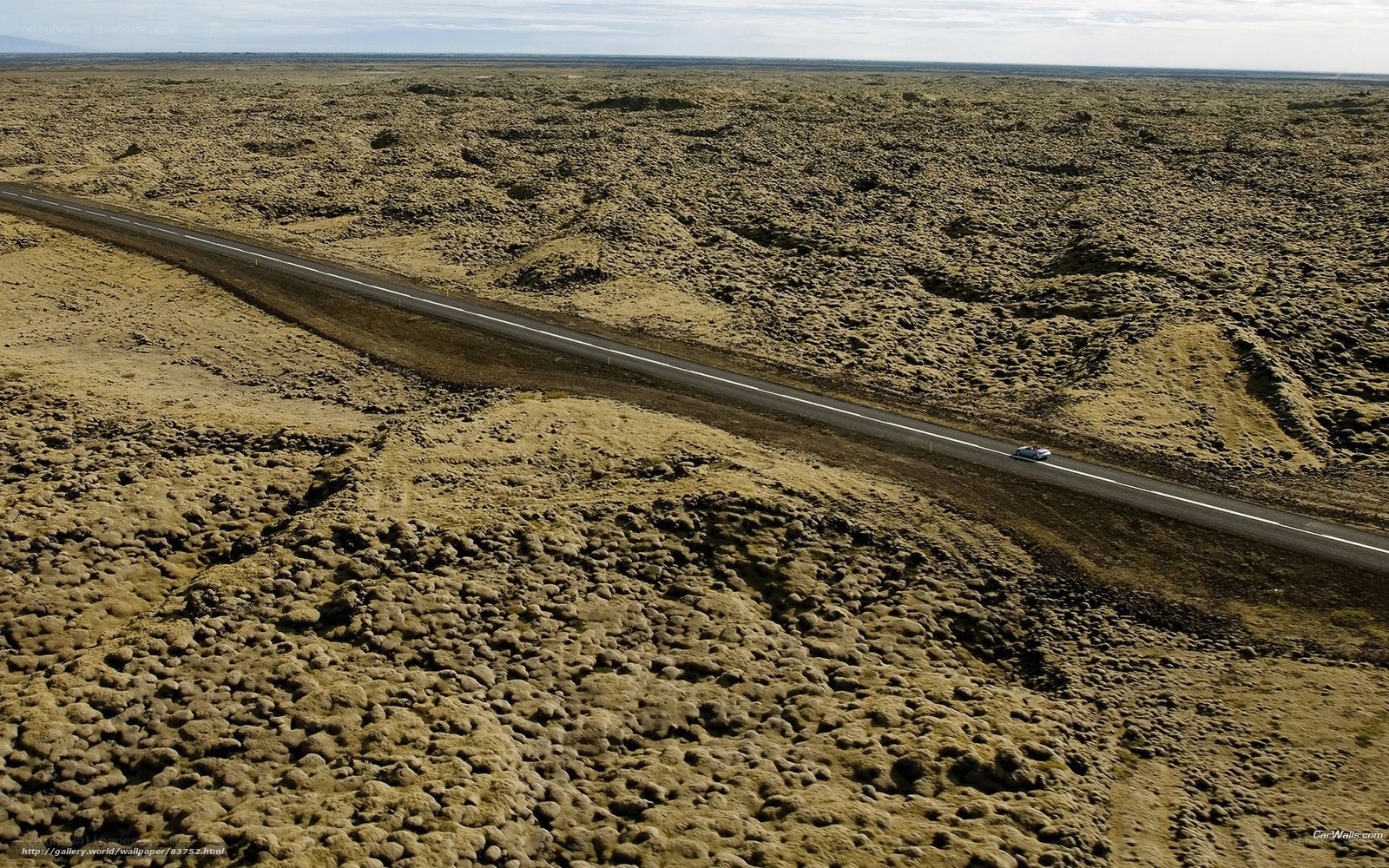 Car on a road in a barren landscape