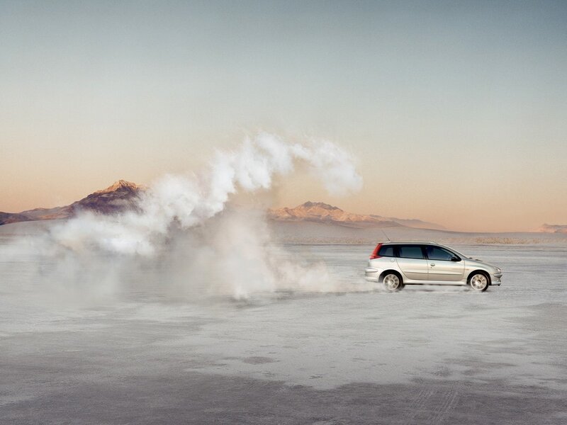 Car on a salt flat with smoke