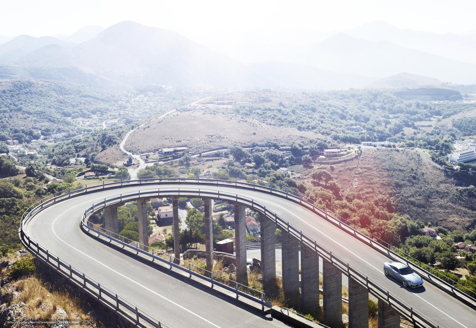 Car on a winding mountain bridge