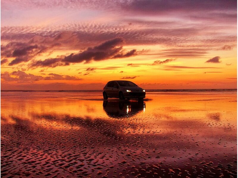 Car on Beach at Sunset