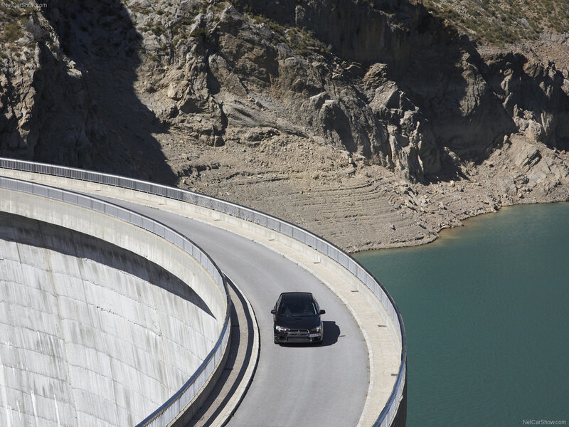 Car on curved dam road