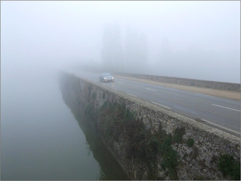 Car on Foggy Bridge