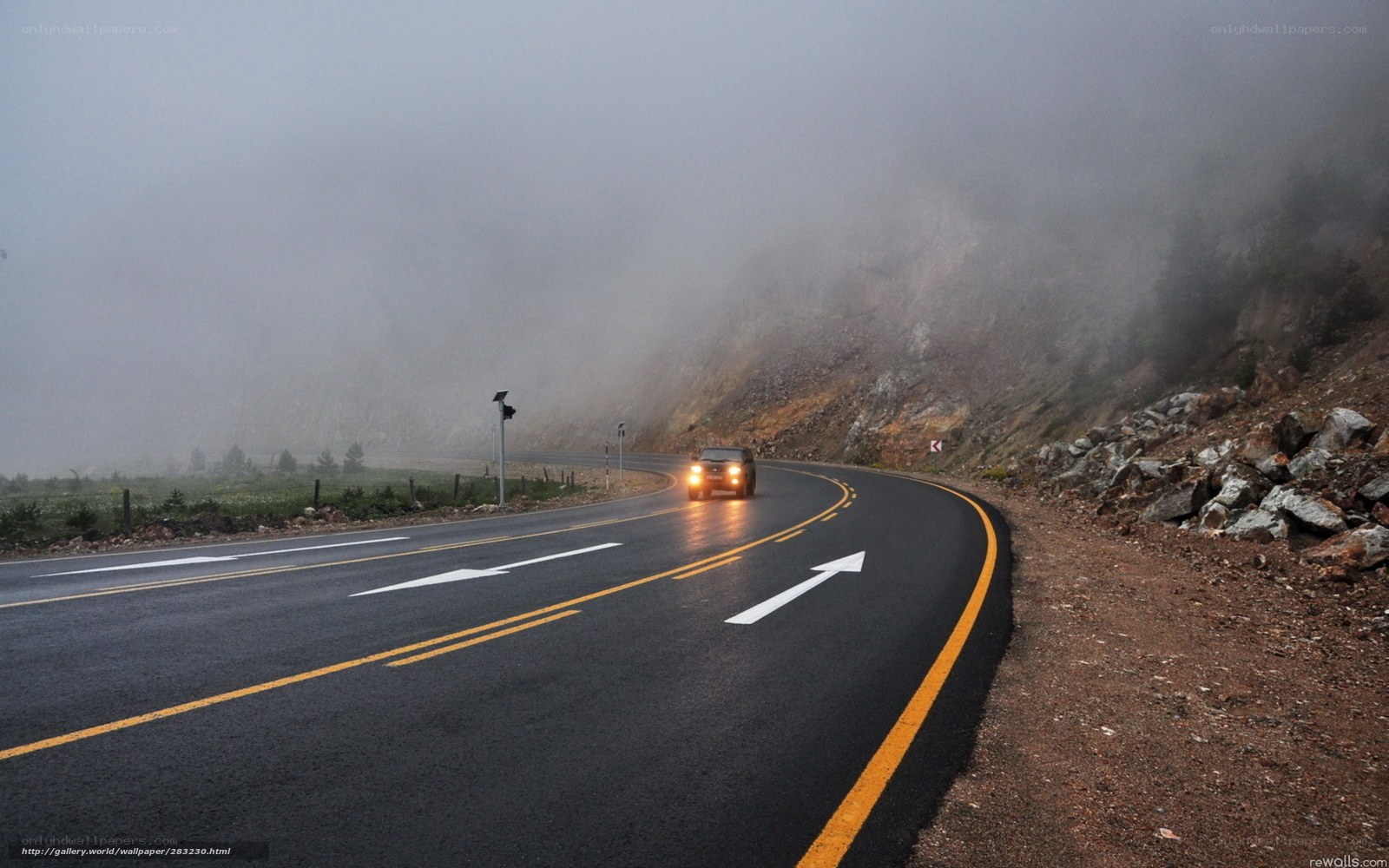 Car on foggy mountain road