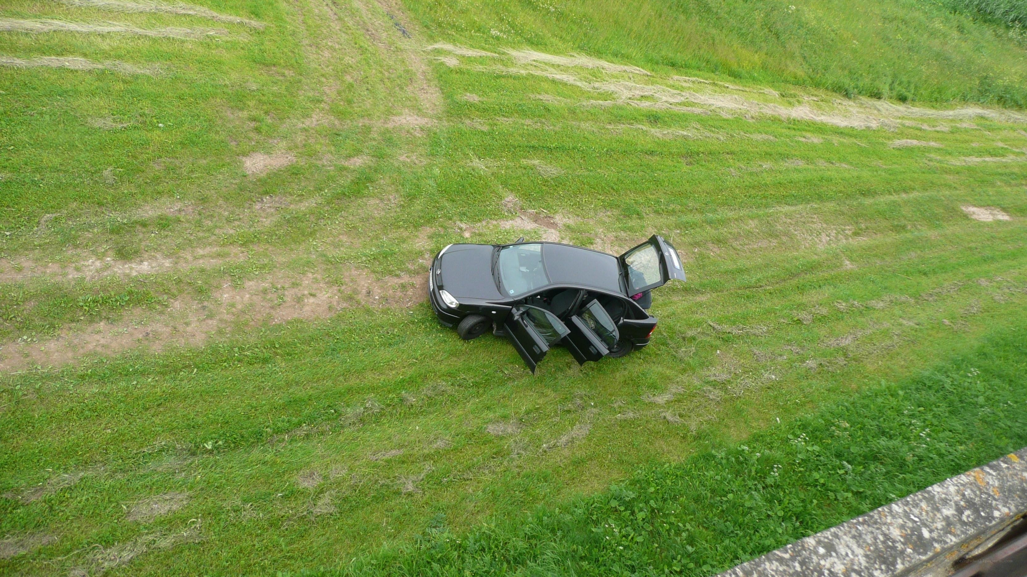 Car on grassy slope