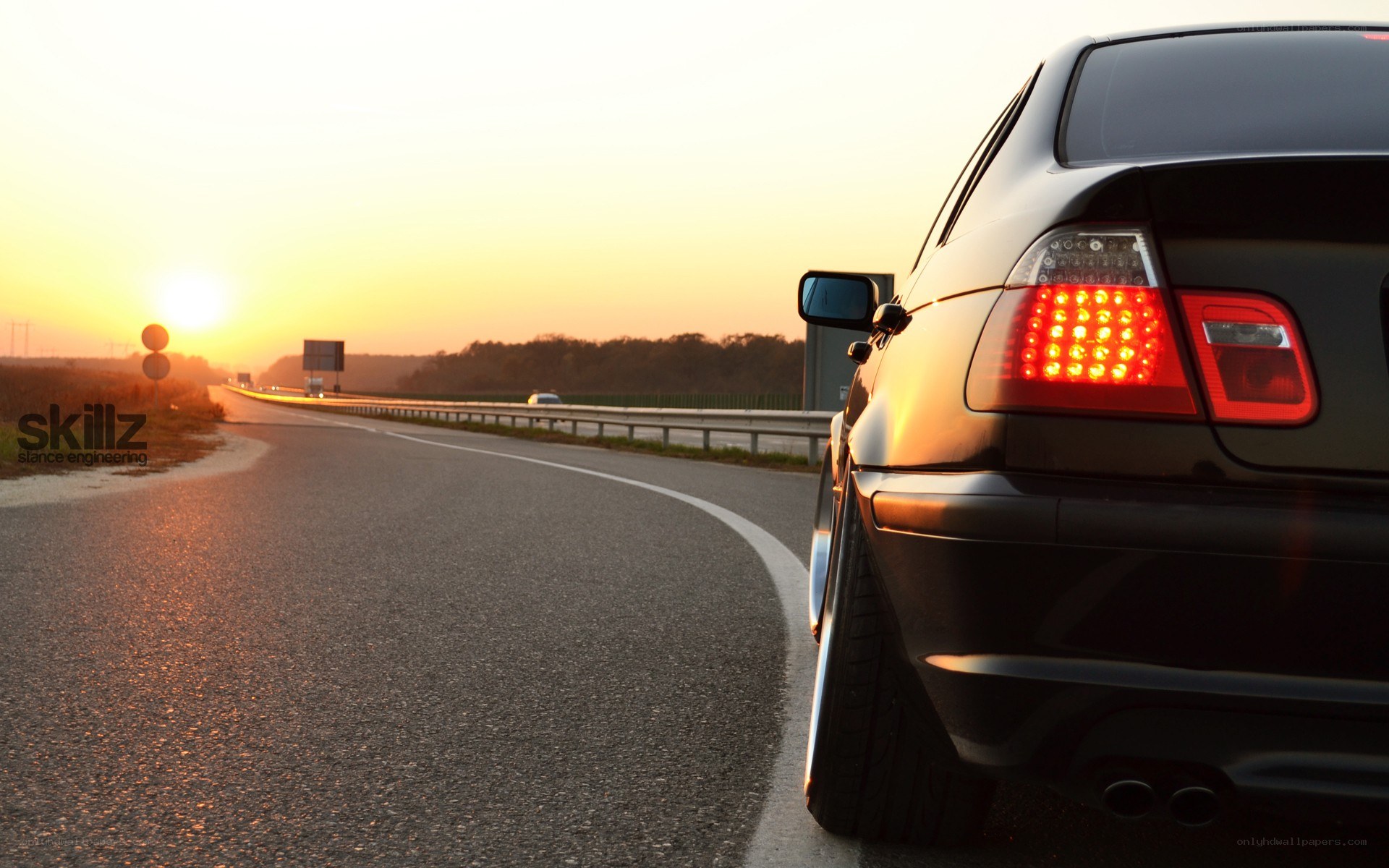 car on highway at sunset