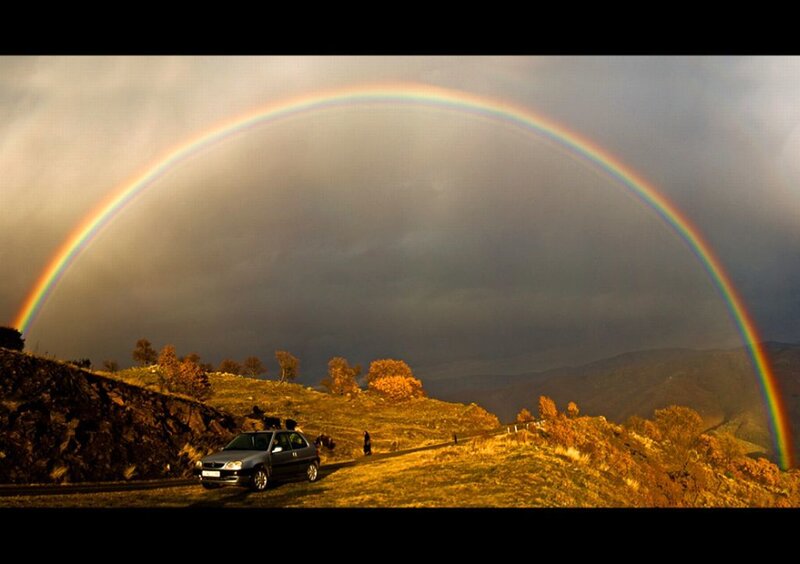 Car on Hill under Rainbow