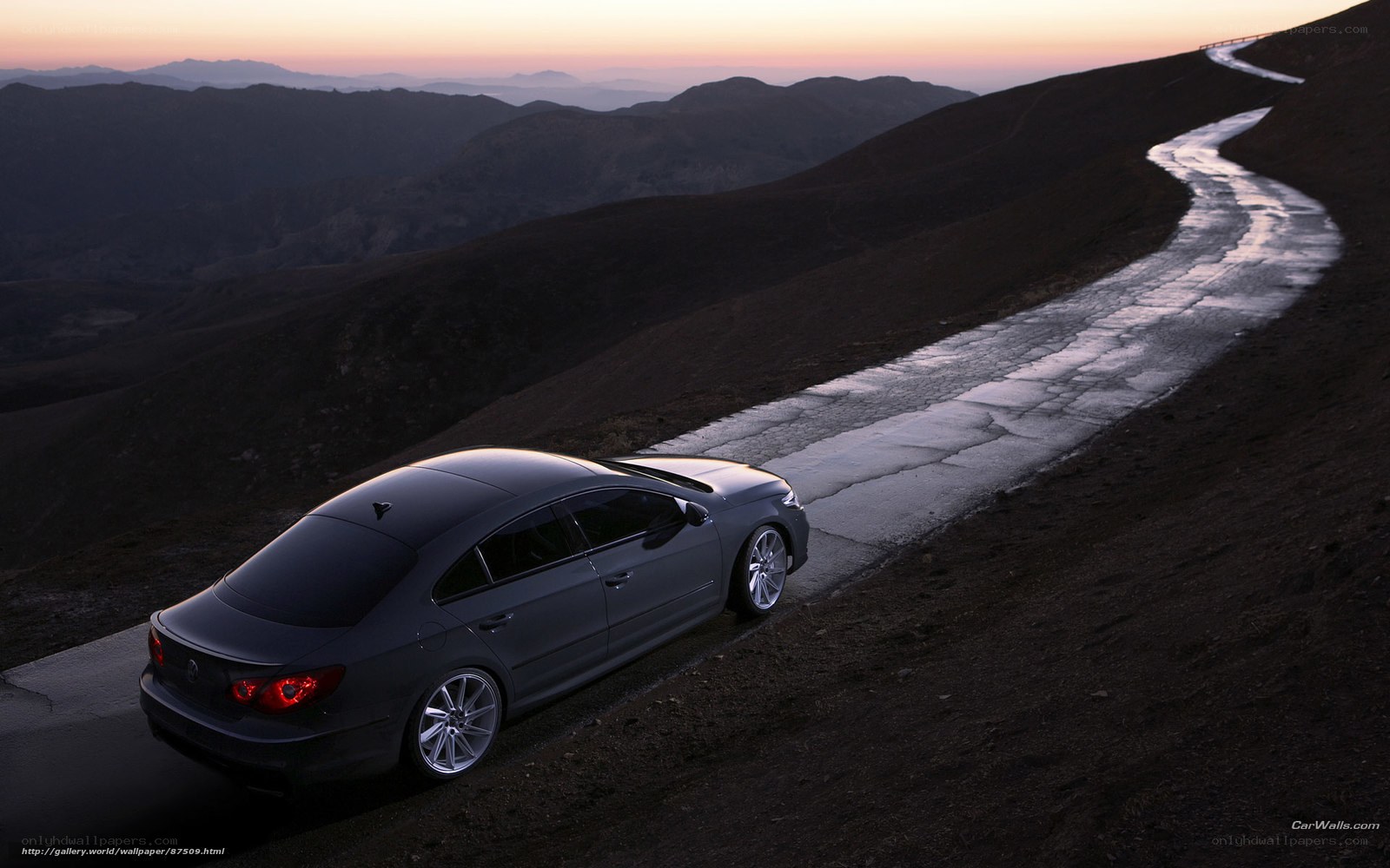 Car on mountain road at dusk