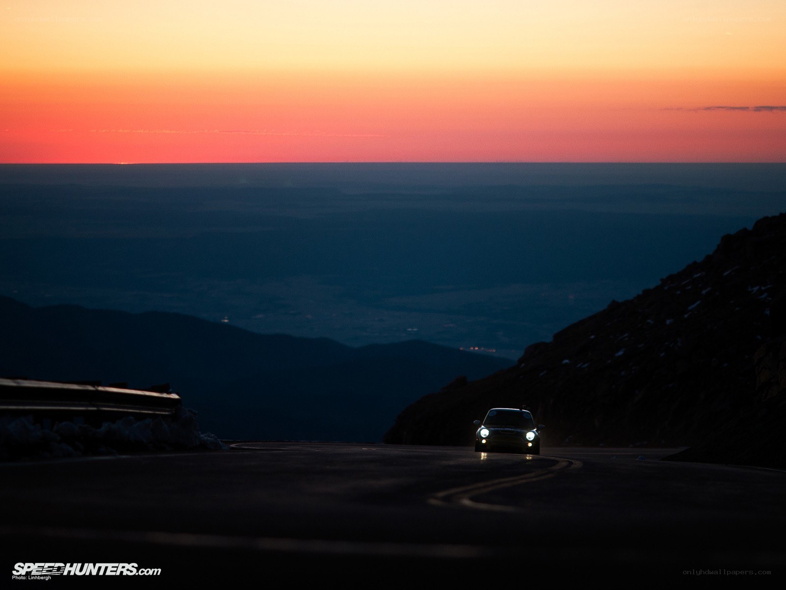 Car on mountain road at sunset