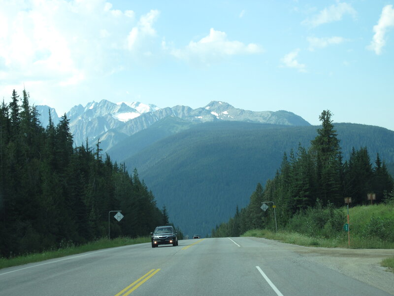 Car on Mountain Road — Green, Serene, Afternoon