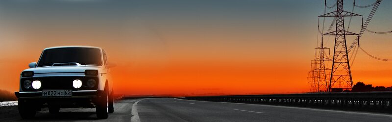Car on road at sunset