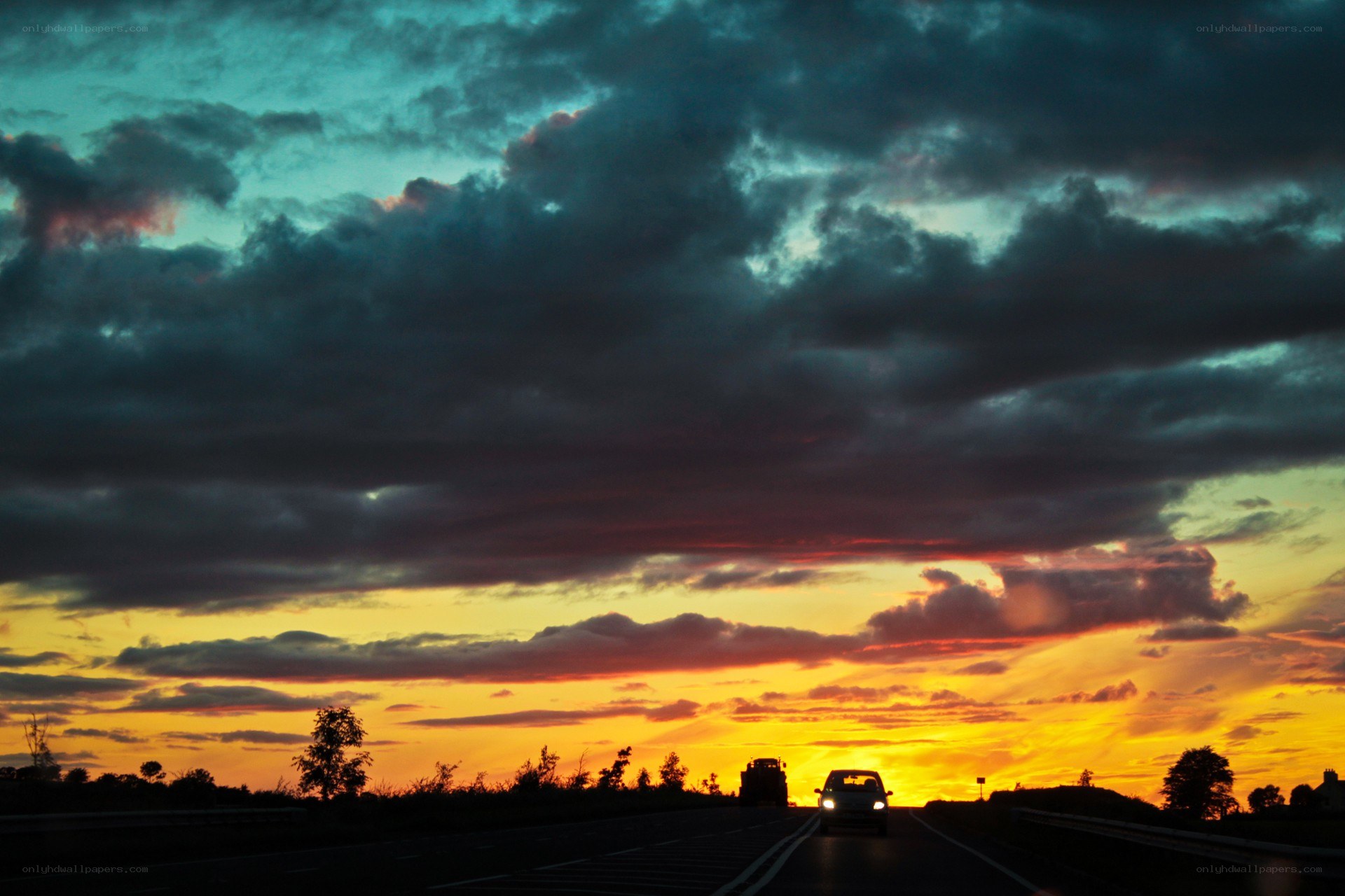 Car on road at sunset