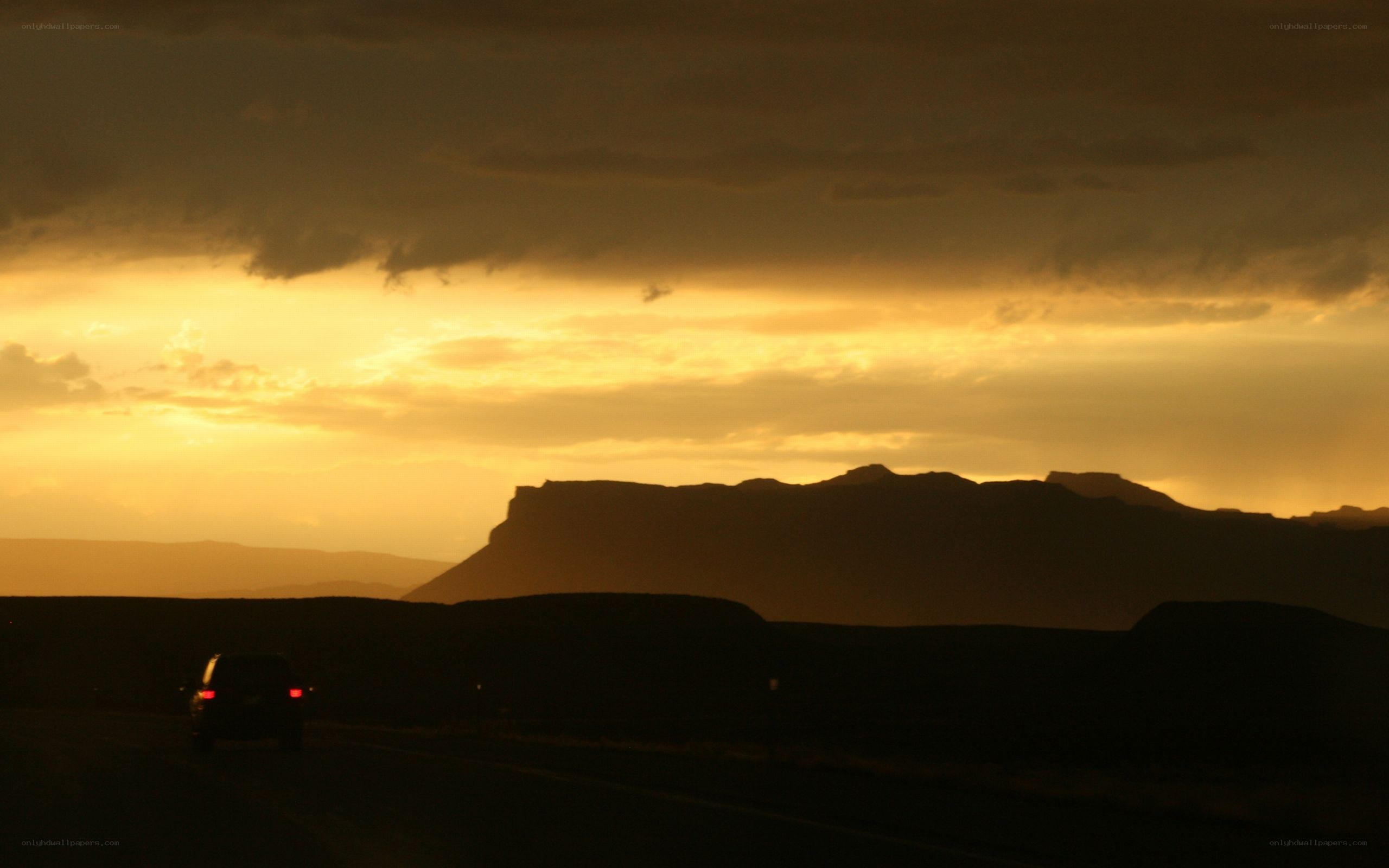 Car on road at sunset