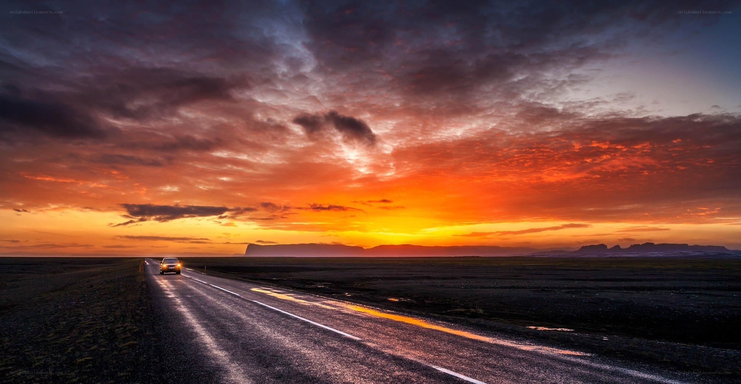 Car on road at sunset