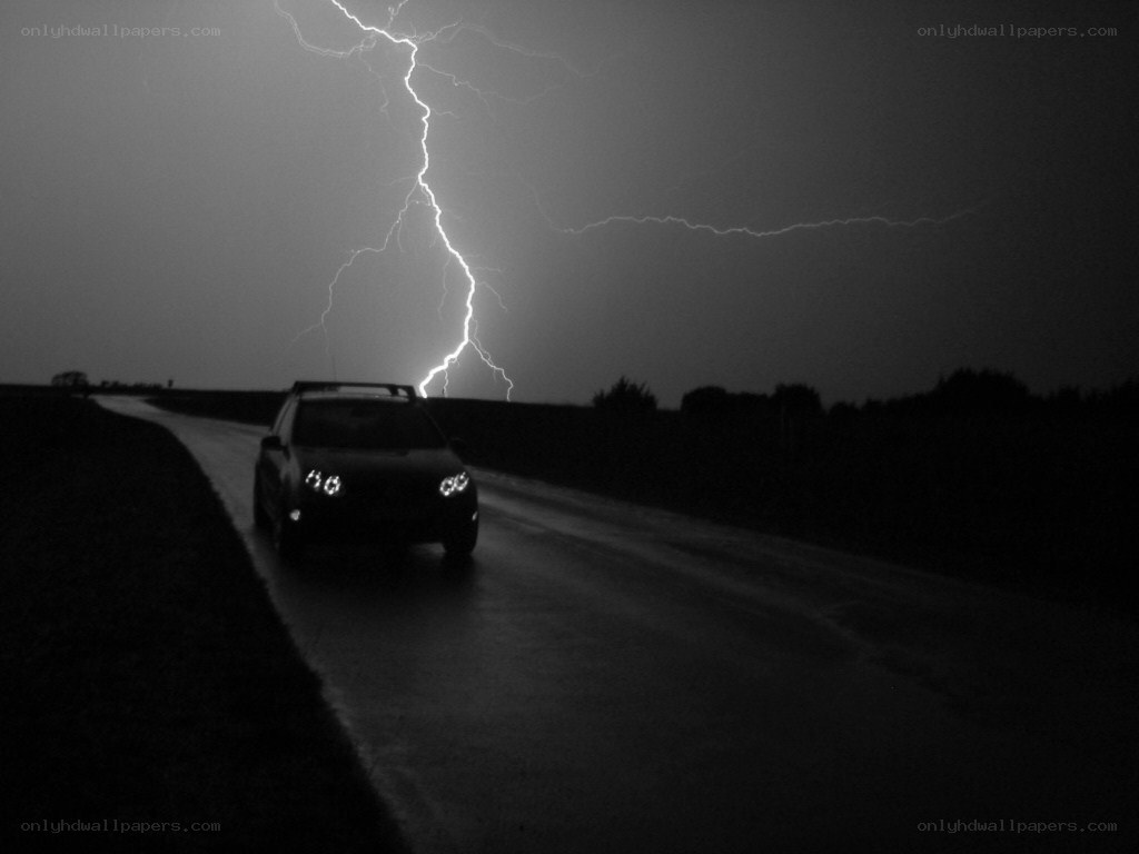 Car on road during lightning storm