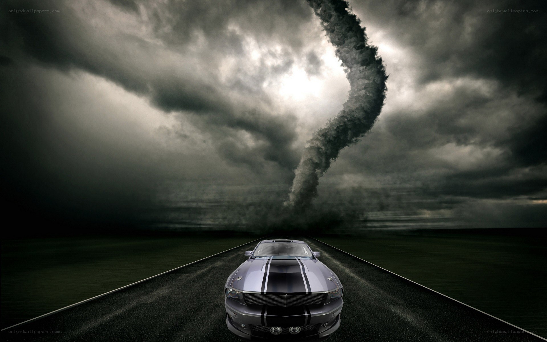 Car on road facing tornado